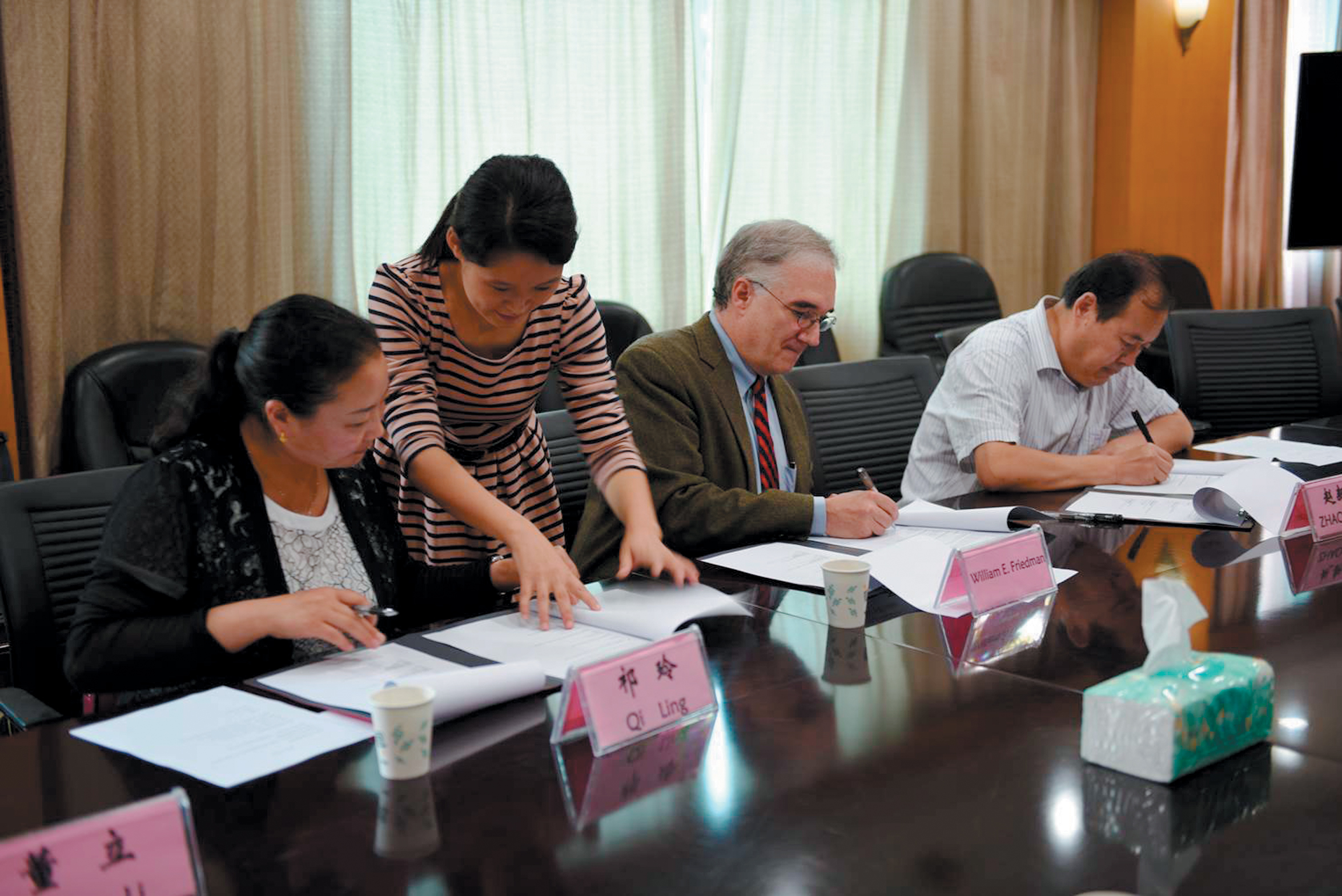 Photograph of leaders signing collection agreement