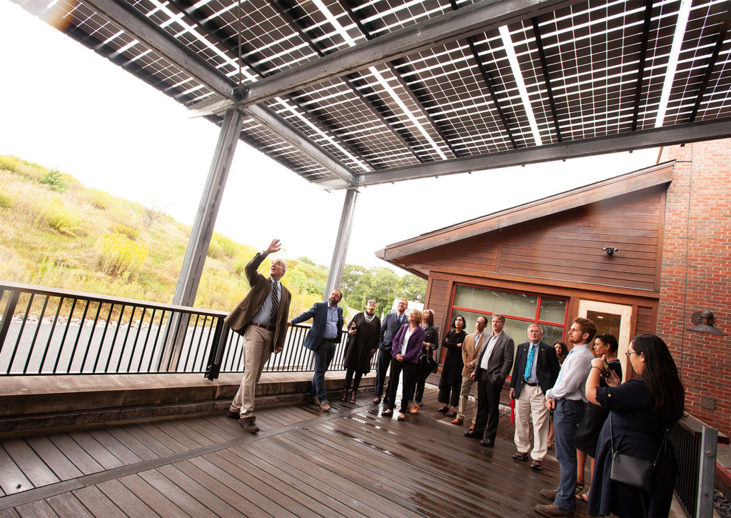 Ned Friedman and city officials view solar panels at Weld Hill