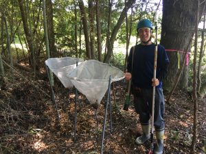 Tatsuhiko Shibano stands next to two of the seed collection traps