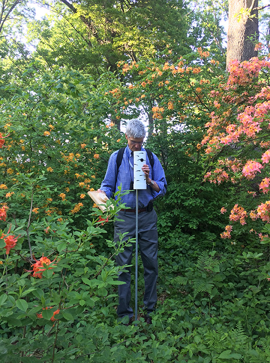 Man checking chickadee box.