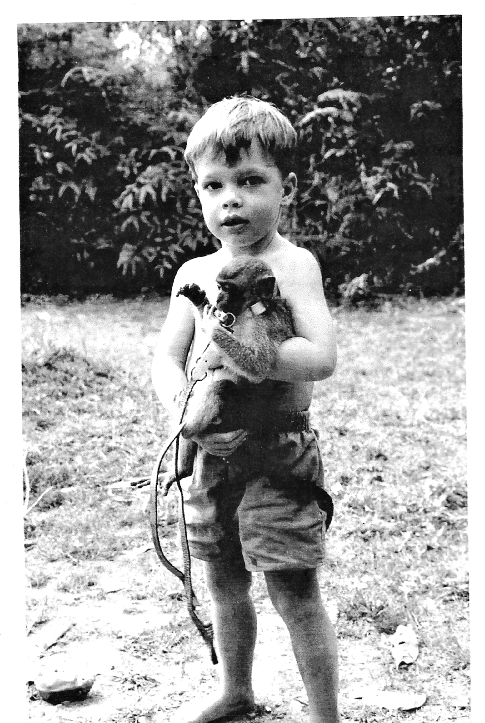 Photo of young boy holding monkey