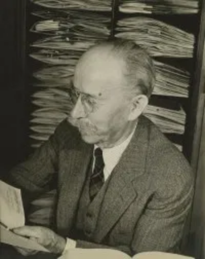 Alfred Rehder examining a Rhododendron specimen in the Herbarium of the Arnold Arboretum, 1939. Photograph by Dmitri Kessel.