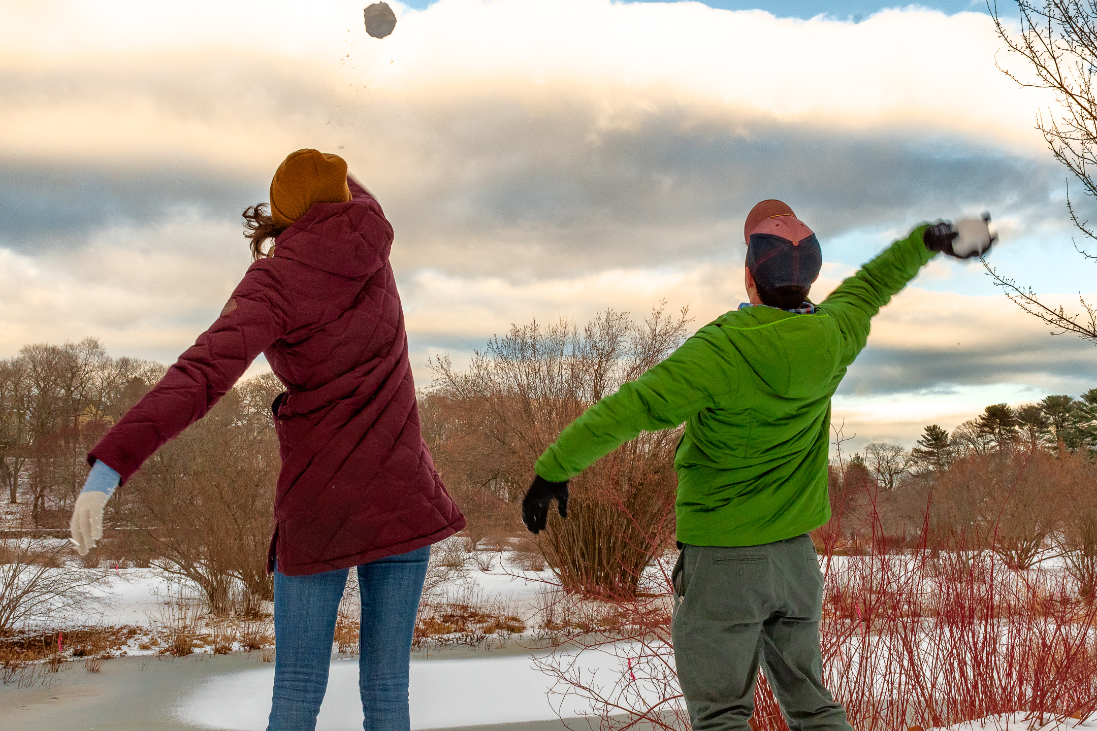 Two persons throwing snowballs