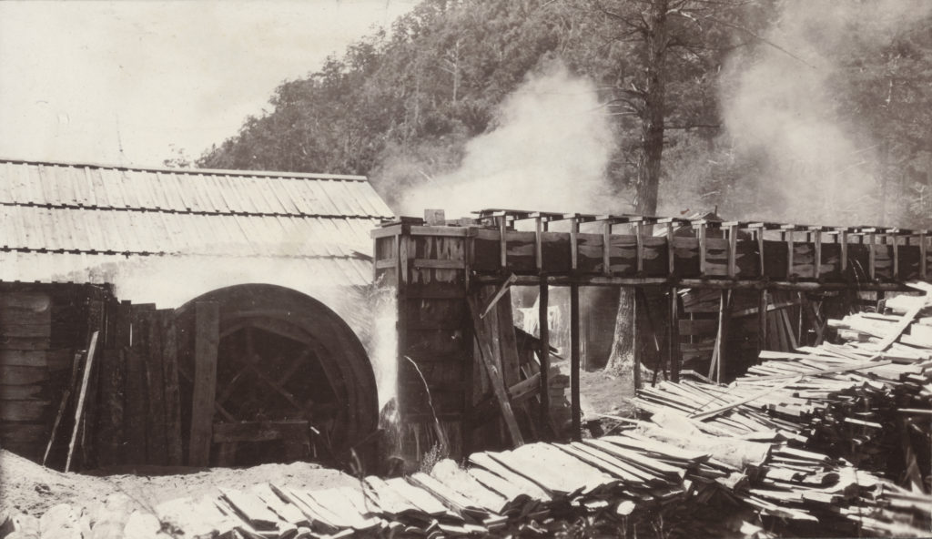 A sawmill being powered by a water wheel near Yumoto, Japan in a photograph by John Jack, August 11, 1905.