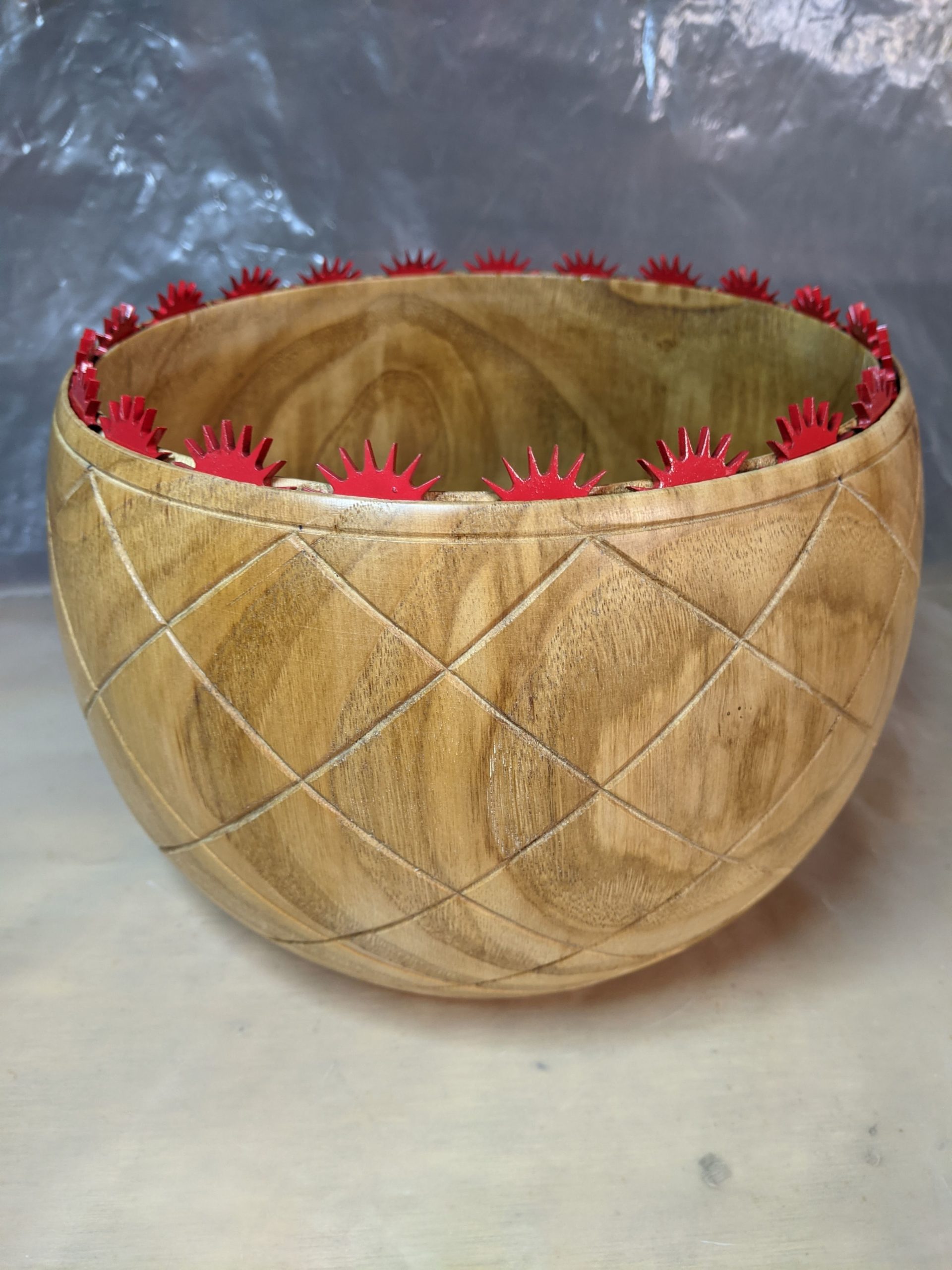 Wooden bowl with sun-like cut-outs around the top edge