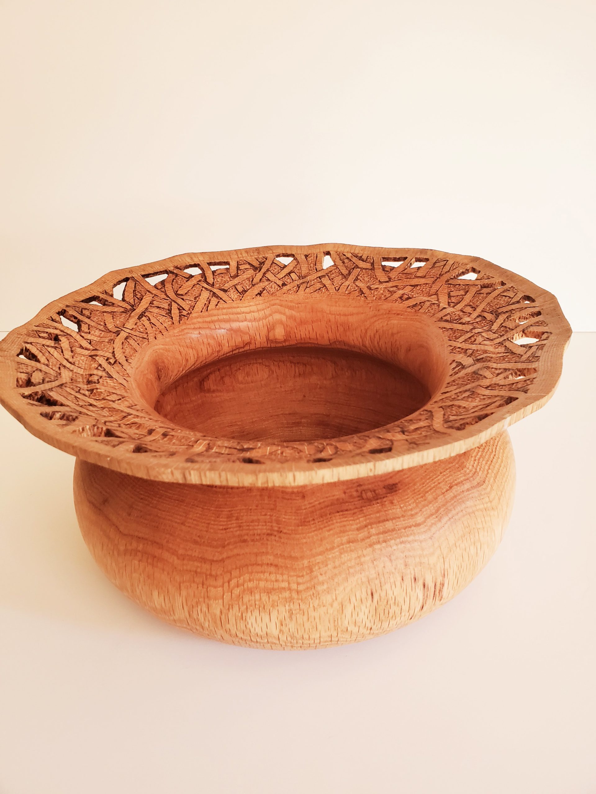 Turned wood bowl with intricate overhangin lip