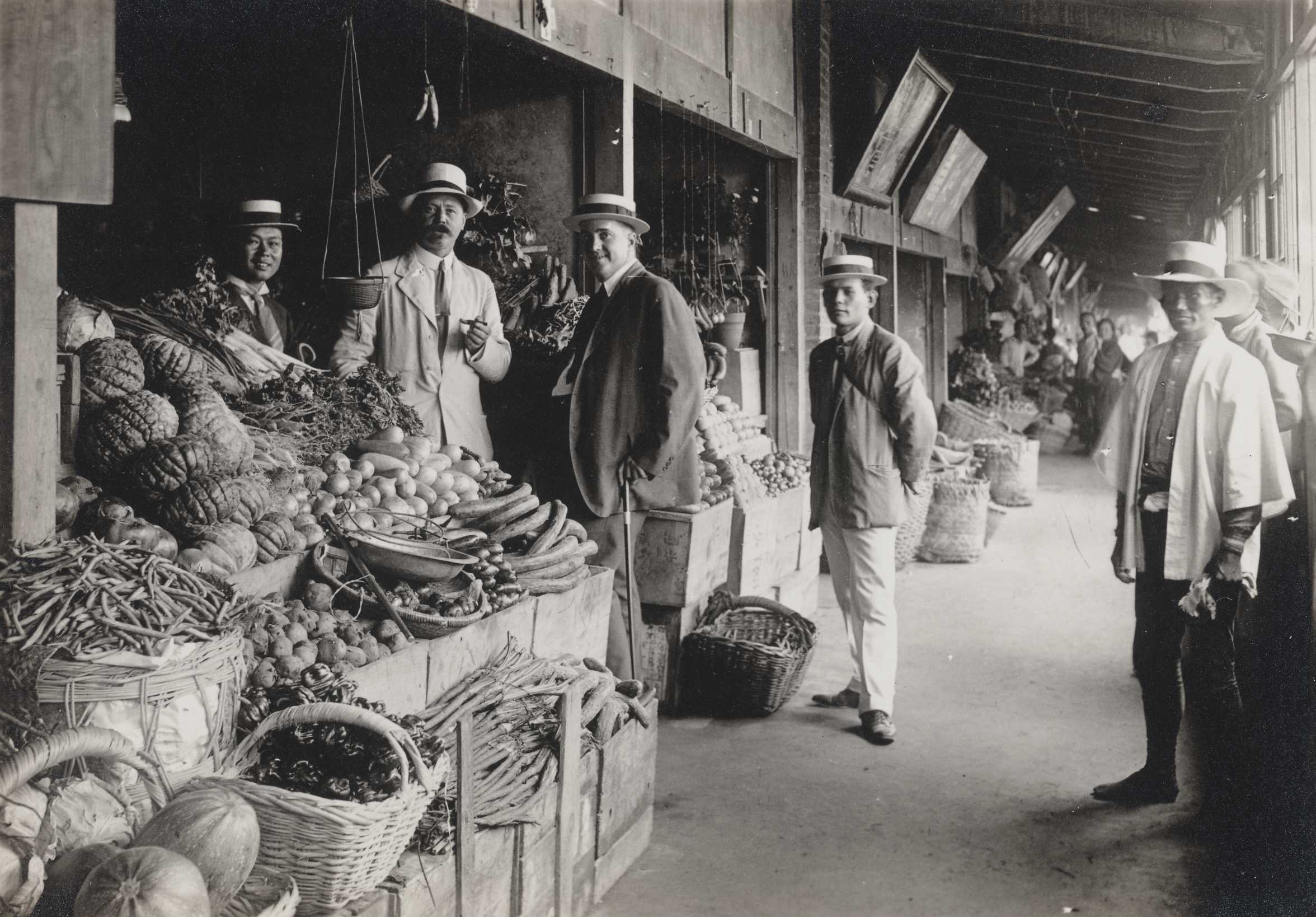 Ernest Wilson (second from the left) at a Japanese fruit and vegetable market. His "most efficient" assistant Mr. Morita stands second from the right. Summer 1918.