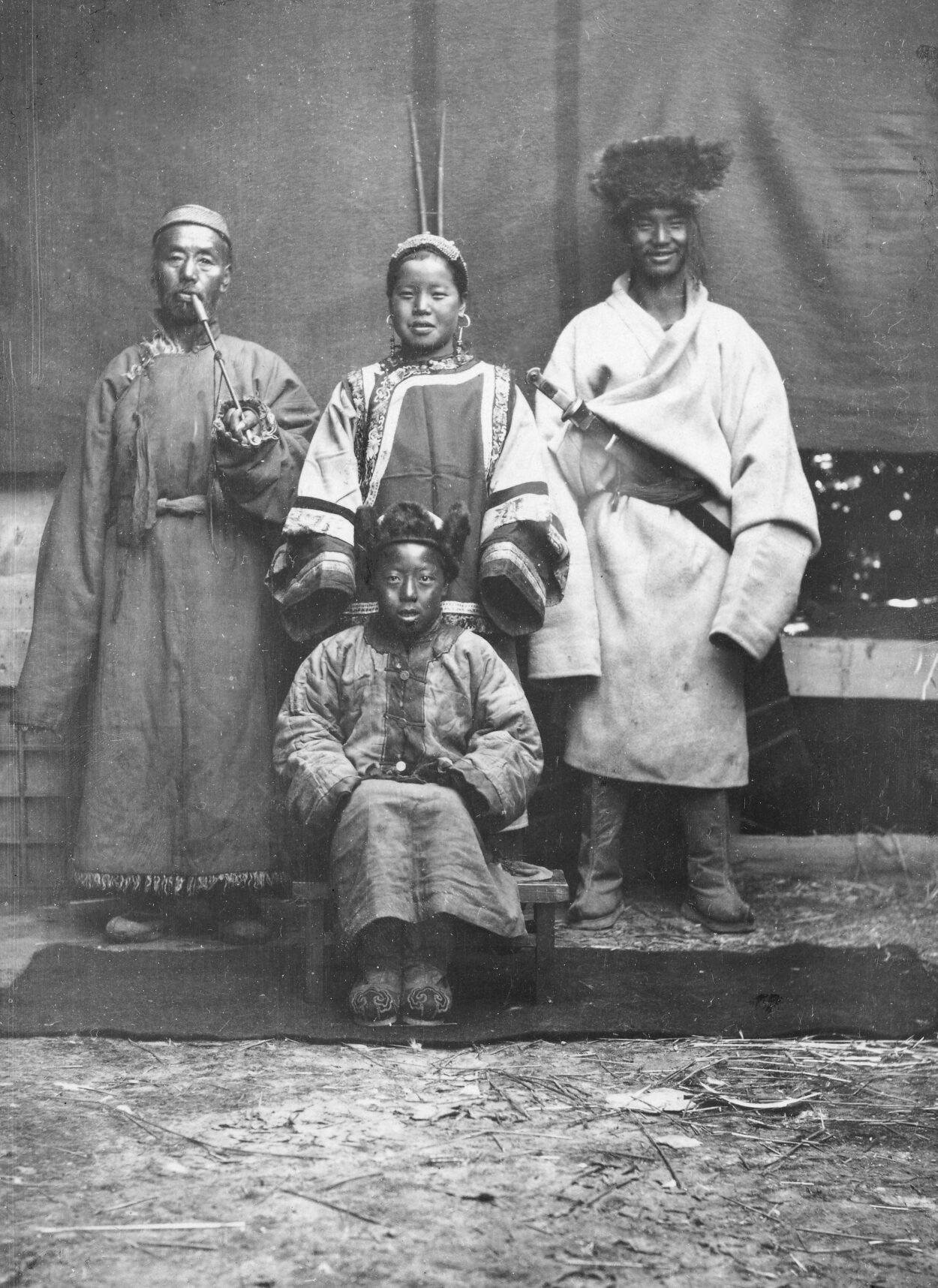 Black-and-white photograph of a Tibetan family with four members