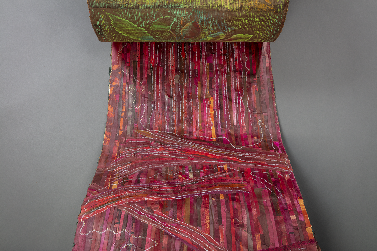 art scroll with tiny text and many colors of paper and silk
