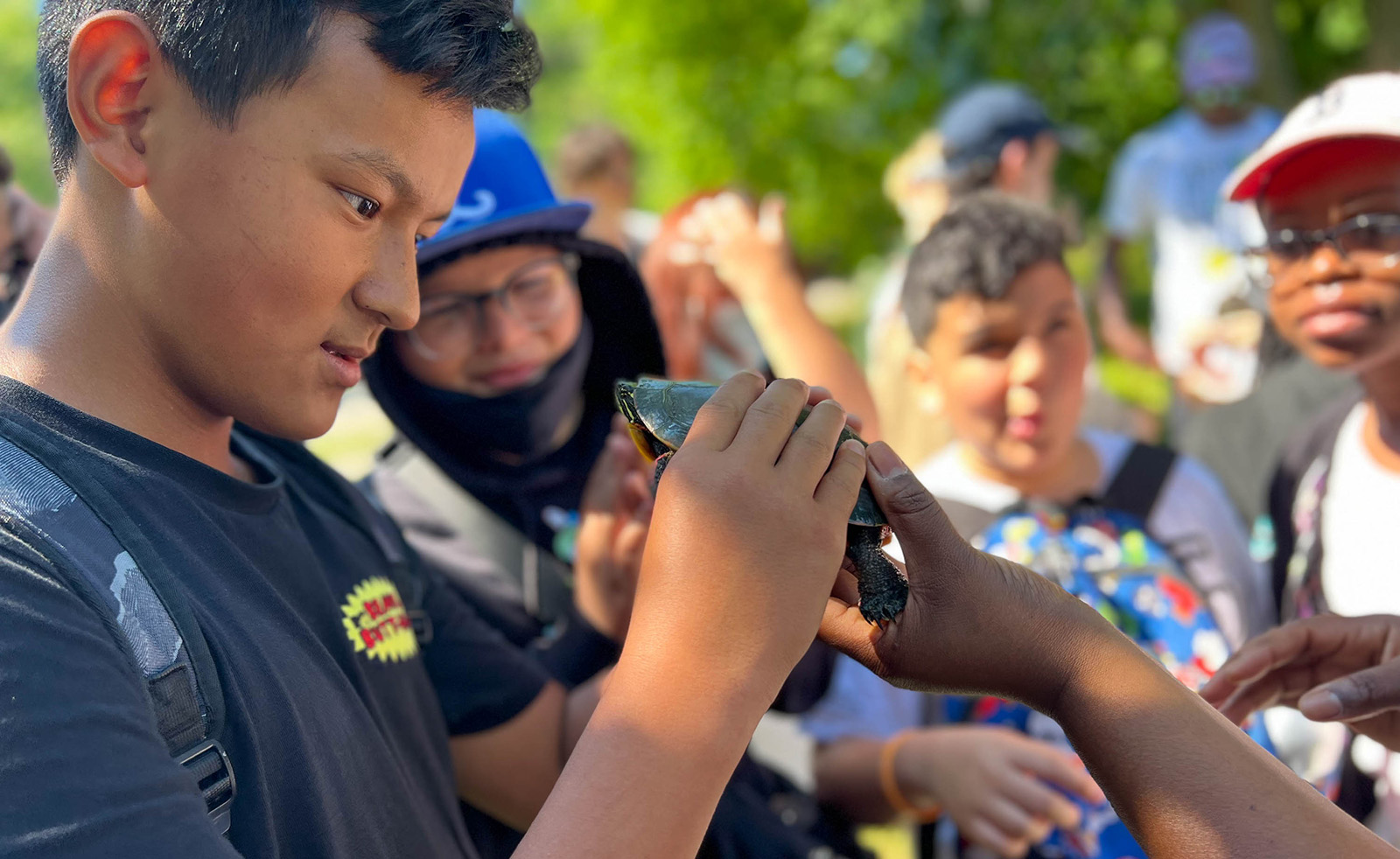 Arboretum Young Scientists observes a turtle at the Arboretum ponds