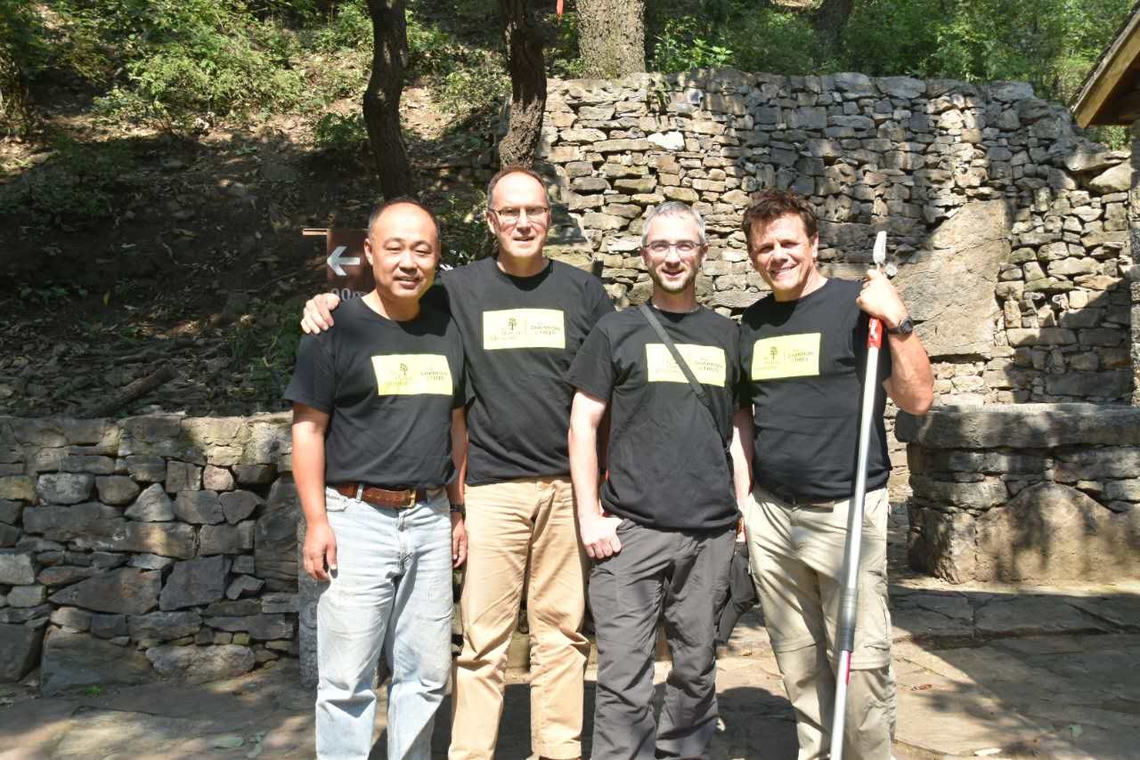 NACPEC 2015 team members Kang Wang, Tony Aiello, Michael Dosmann, and Kris Bachtell standing at the Manghe Nature Reserve wearing matching black t-shirts.