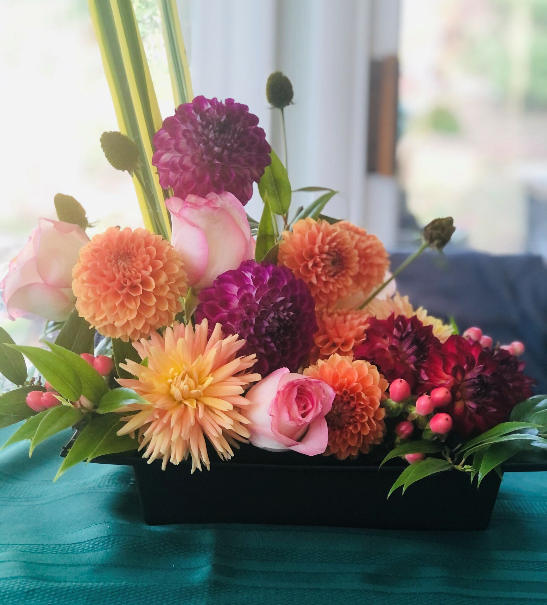 Arrangement of orange, red, purple, and pink dahlias