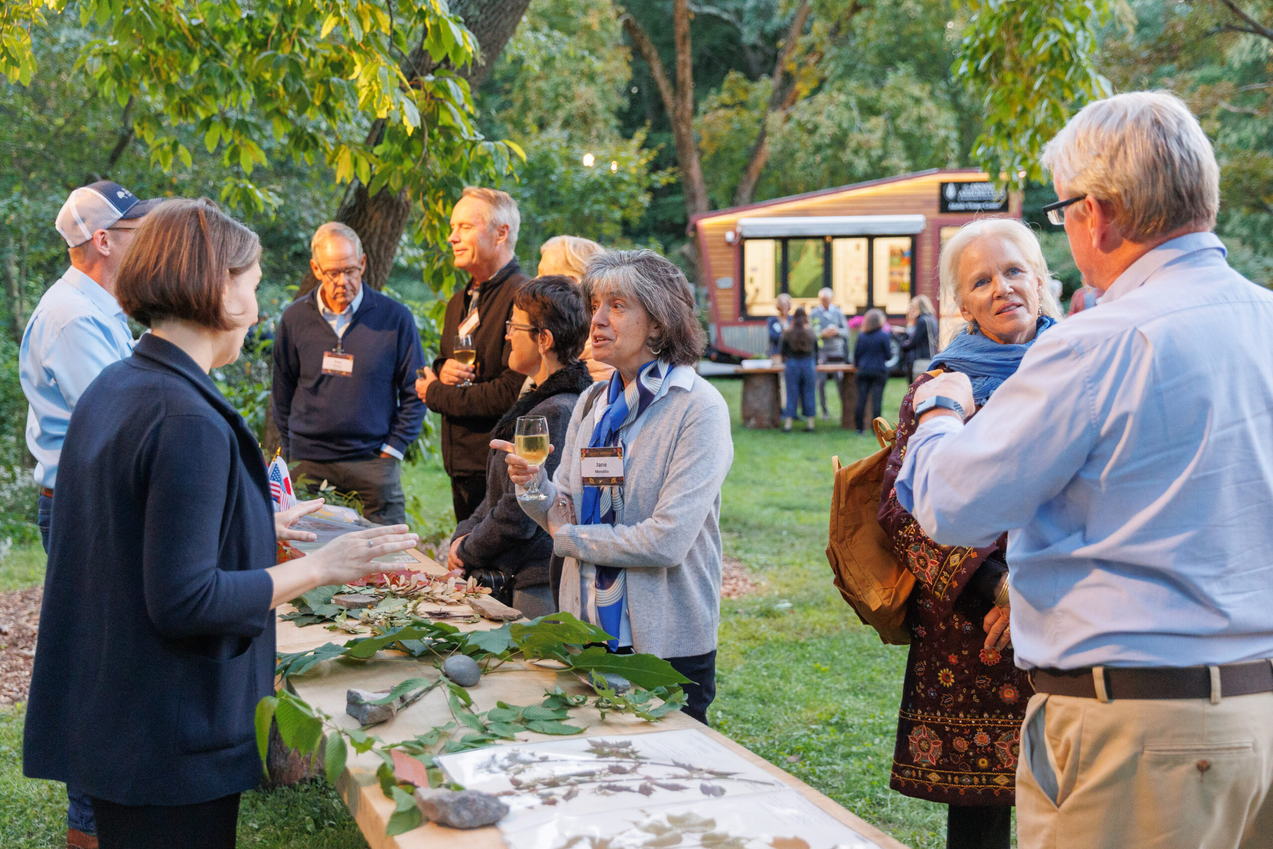 Guests gather to view displays in the maple collection at Magical Meanderings Autumn Dinner, September 19, 2023