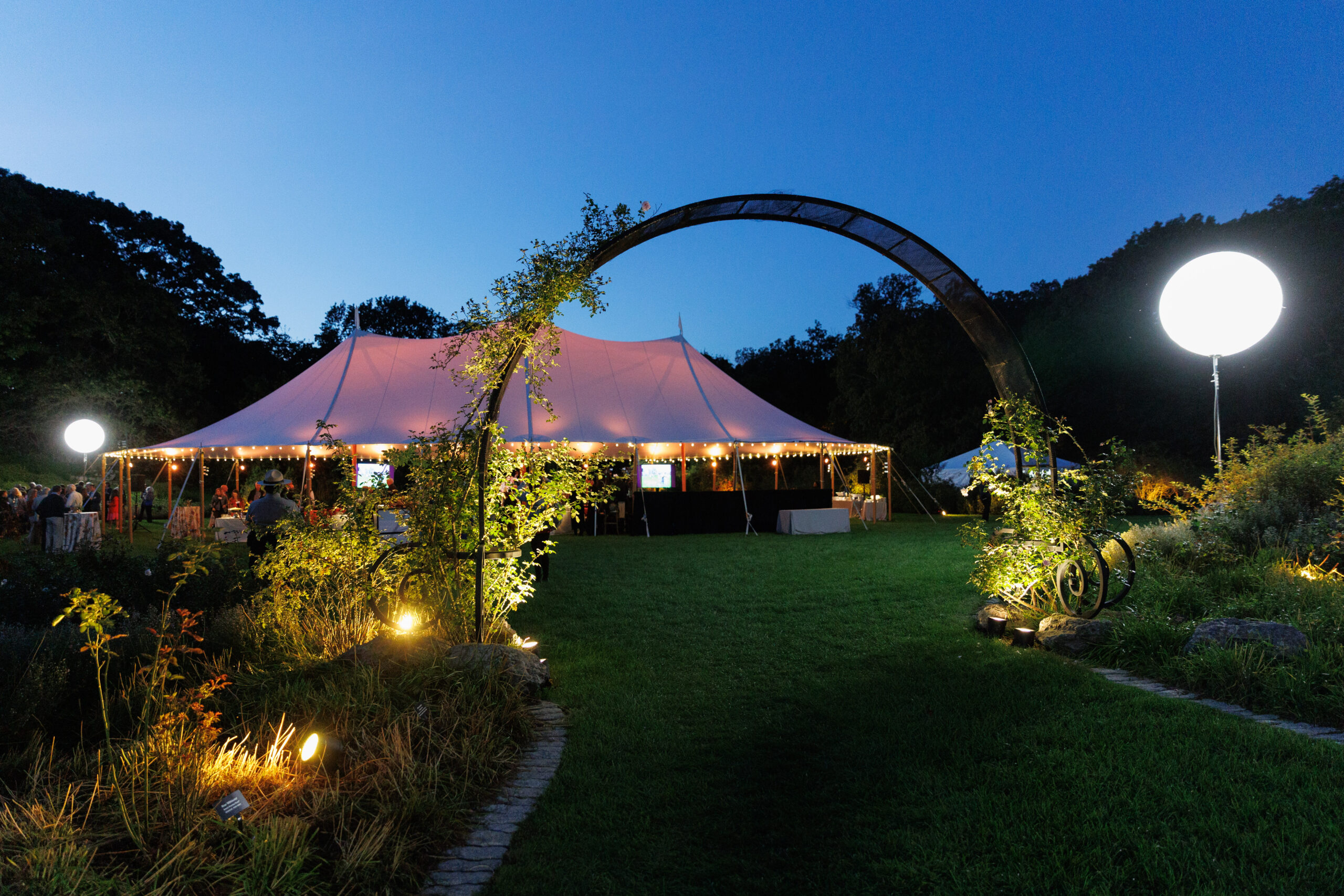Event tent illuminates the Bradley Rosaceous Collection at Magical Meanderings Autumn Dinner, September 19, 2023