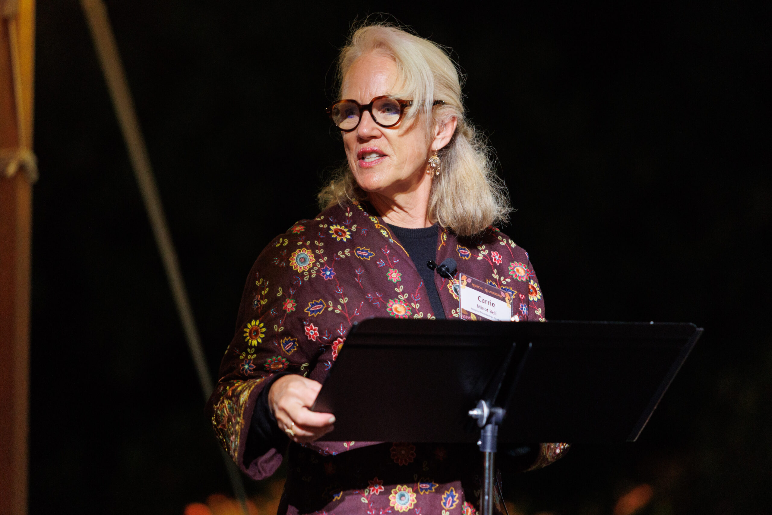 Event co-chair Carrie Bell addresses guests at Magical Meanderings Autumn Dinner, September 19, 2023