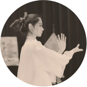 A black and white image of a woman in a white robe doing tai chi
