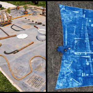 A large sale with historical objects placed on top next to a finished cyanotype print