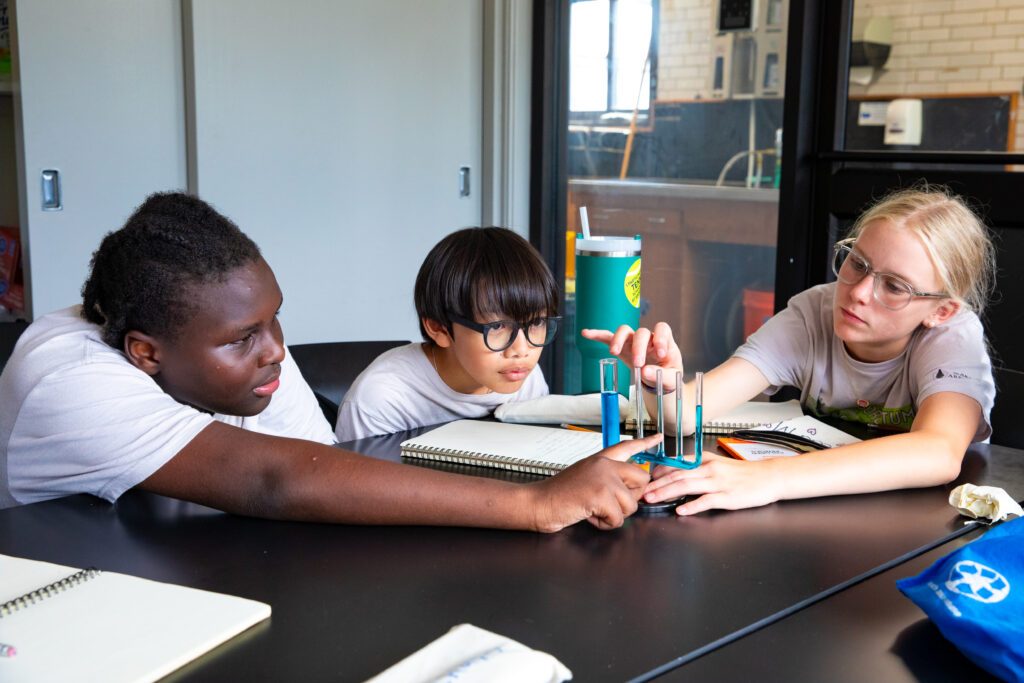 Arboretum Young Scientists perform an experiment in the Dana Greenhouses classroom.