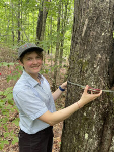Photo of Emma Daily measuring the DBH of a tree