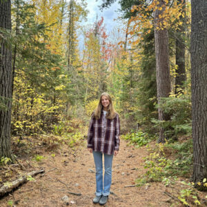Alice Wagner-Hemstad standing on a path in the woods.