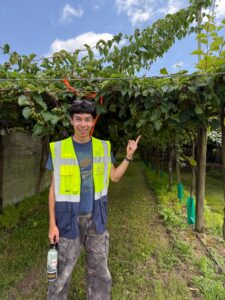 Photo of Zachary Ruwitch pointing at a tree.