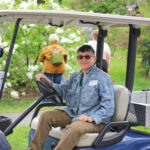 Marla Greenman driving a golf cart on Lilac Sunday