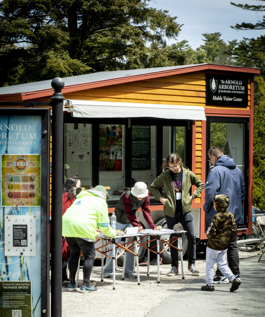 Staff greet visitors in the landscape in the Mobile Visitor Center.