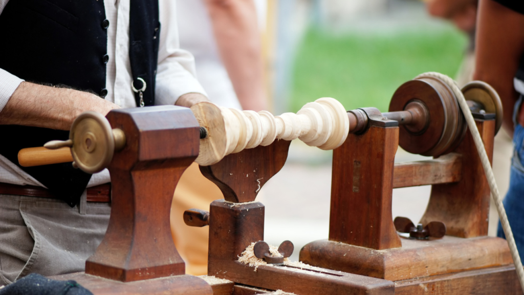 Wood lathe outdoors with green grass in background